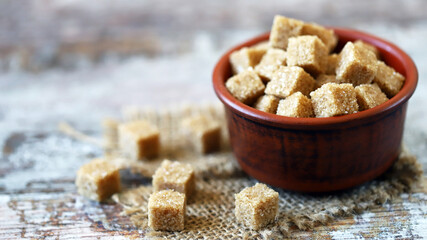 Brown sugar cubes in a bowl. Sugar for mojito cocktail. Healthy diet. Stop diabetes concept.