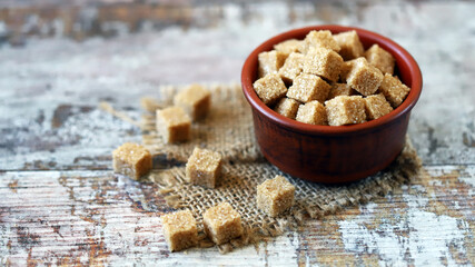Brown sugar cubes in a bowl. Sugar for mojito cocktail. Healthy diet. Stop diabetes concept.