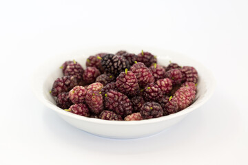 ripe black mulberry in a bowl