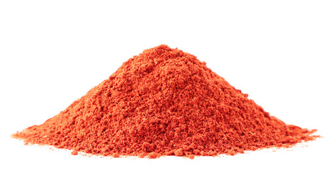 Pile of red ground pepper close-up on a white background. Isolated