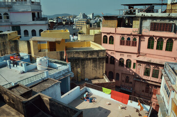 Fototapeta na wymiar bright house yellow, blue, pink, the view from the roof, Udaipur, India