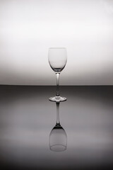 Empty wine glass on black glass.