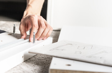 close up of a man assembling diy furniture
