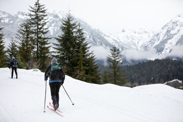 Cross country skiers on a mountain trail, in a snow sport scene