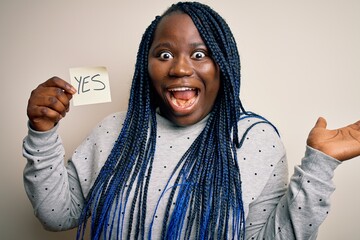 Young african american plus size woman with braids holding reminder paper with yes message very...