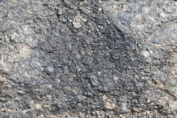 Natural stony background in grey color with copy space. Materials for designers, empty wall made of rock, banner