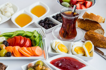 Traditional Turkish breakfast white table with Turkish Tea and bagel.