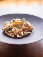 farfalle with shrimp in black plate