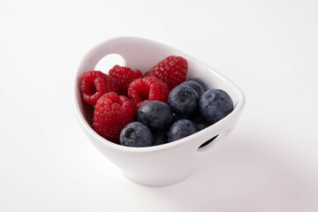 blueberries and raspberries in a cup