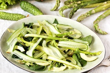 salad of asparagus and cucumber shavings and spinach, thin slices of vegetables with olive oil