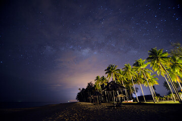 Beautiful village and milky way at beach