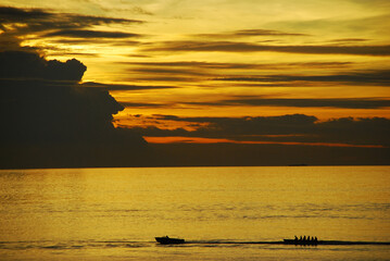 Silhouette of Banana boat and beautiful sunset background