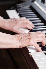 Elderly pianist plays the electronic piano