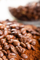 Coffee Beans and Grounds Close up. Background. Coffee beans in a glass jar in the background.