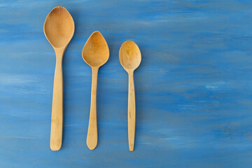 wooden spoon on the blue background.