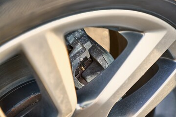 Wheel of modern SUV vehicle, break caliper and rotor, car detail closeup