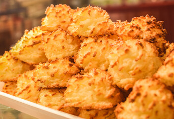 Coconut candies, coconut candy on the shelf in the bakery, sweets from the bakery