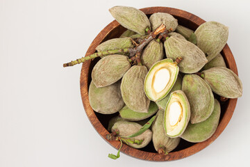 Fresh raw  almonds in the pod isolated on white background