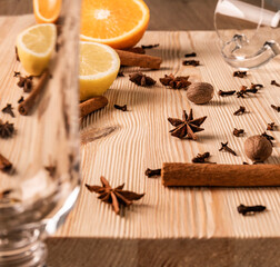 Differential focus. Limpid empty glasses for mulled wine, anise flowers stars, nutmegs, cloves,...