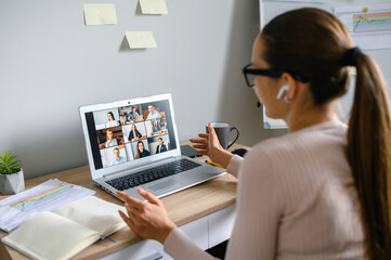 Virtual conference, online meeting. Business woman using laptop app for communicating with several...