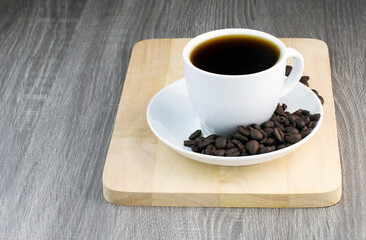 black coffee with coffee bean on wooden table