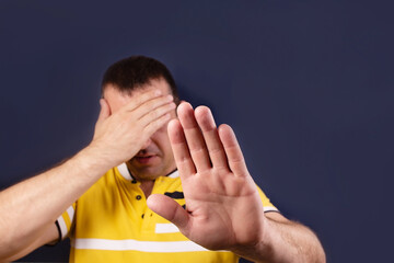 man closed his eyes with his hand, protests