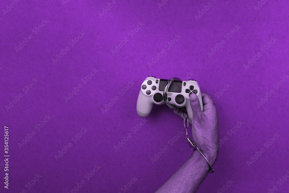 Wall mural video game joystick and handcuffs isolated. addiction to games concept image.