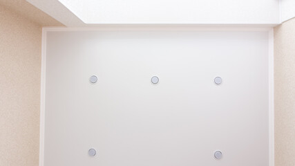 Room lighting by the window, five bulbs around the perimeter of the stretch ceiling