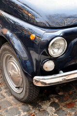 close-up of the front round headlight of an old car