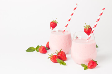A glass of fresh strawberry smoothie on a white background. Summer drink shake, milkshake and refreshment organic concept.