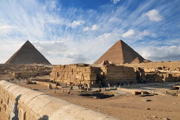 Foto op Canvas Chefren's pyramid and the Cheops pyramid on a background of blue sky with clouds © Sergey