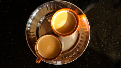 Top view of two cups of Masala Chai, a traditional aromatic beverage originating from India
