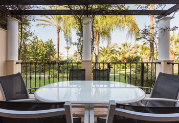 Veranda, terrace of the house, hotel with table, armchairs. View, landscape of the park, nature.