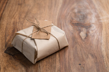 Chocolate brick wrapped in paper on wood backgorund