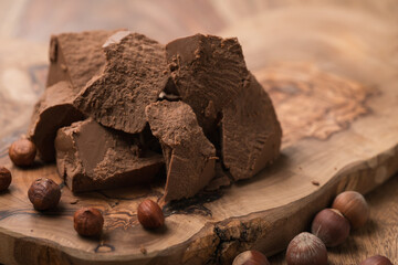 Gianduja chunks on wood board background