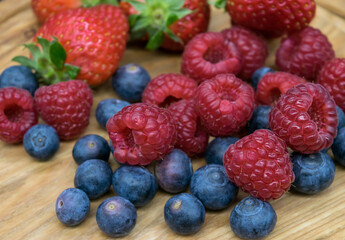 Ripe juicy blueberries, raspberries and strawberries in close-up