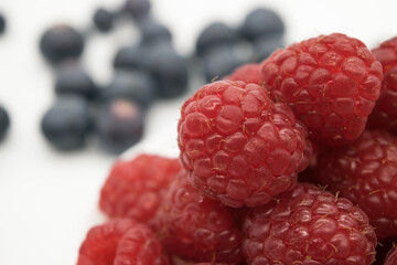 Ripe juicy blueberries and raspberries in close-up