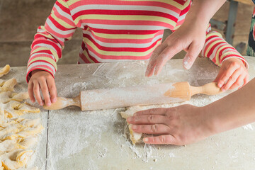 home furnishings. Kitchen. A child from the dough makes cookies. Brushwood. Close-up