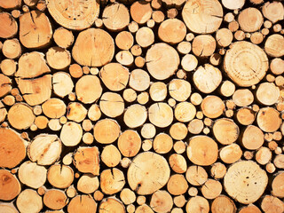 Sawn timber logs stacked for a wood burning stove. Close up in full frame and a horizontal format.