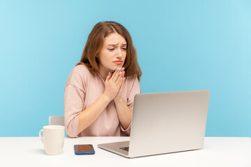 Please, begging for help! Young woman employee holding hands in praying gesture and talking on...
