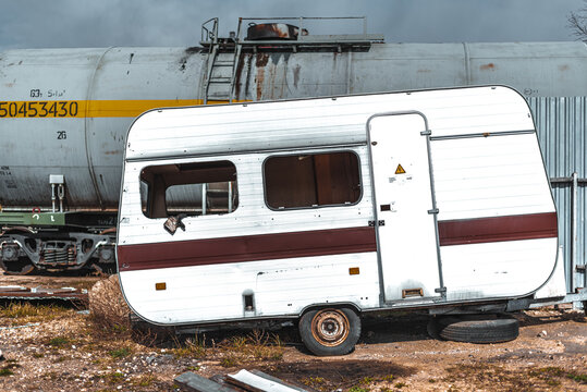 old abandoned, demolished trailer in junkyard