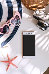 Top view of summer accessories and smart phone on white color background, travel concept. Flat lay , copy space