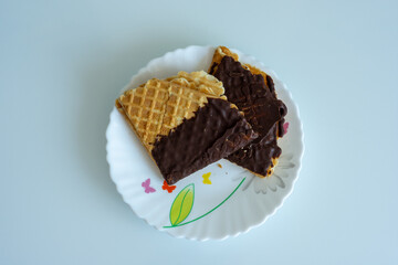 Chocolate covered waffles on a white plate