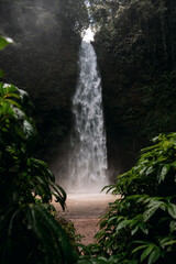 Nungnung Waterfall splashing in Bali Jungle, Indonesia