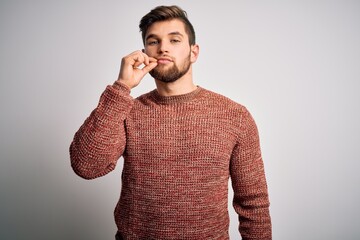 Young blond man with beard and blue eyes wearing casual sweater over white background mouth and...