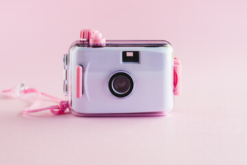 Camera waterproof toy on pink background with copy space