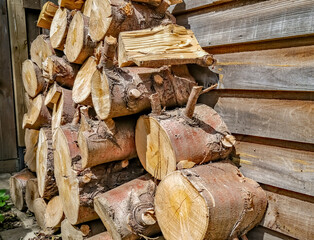  Close up of a stack of wooden logs ready for chopping in to fire wood