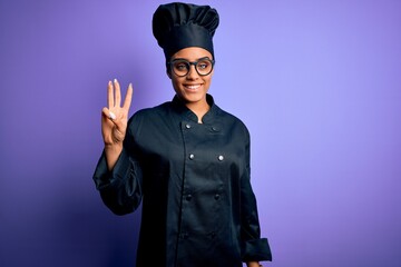 Young african american chef girl wearing cooker uniform and hat over purple background showing and...