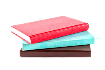 Red and blue and brown notebooks, diaries, men's and women's. Isolated on a white background