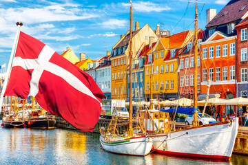 Copenhagen iconic view. Famous old Nyhavn port in the center of Copenhagen, Denmark during summer...